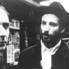 Renegade mathematician Max Cohen (Sean Gullette, left) and the leader of the Kabbalah sect, Lenny Meyer (Ben Shenkman) have a chance encounter on a Chinatown street corner.