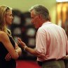 Christina and Harvey talk in the locker room