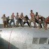 The survivors of a downed aircraft pull together to build a new plane out of the wreckage of the old one.  (L to R) Jacob Vargas, Giovanni Ribisi, Miranda Otto, Hugh Laurie, Scott Michael Campbell, Kevork Malikyan, Dennis Quaid, Tyrese Gibson, Kirk Jones and Tony Curran. 